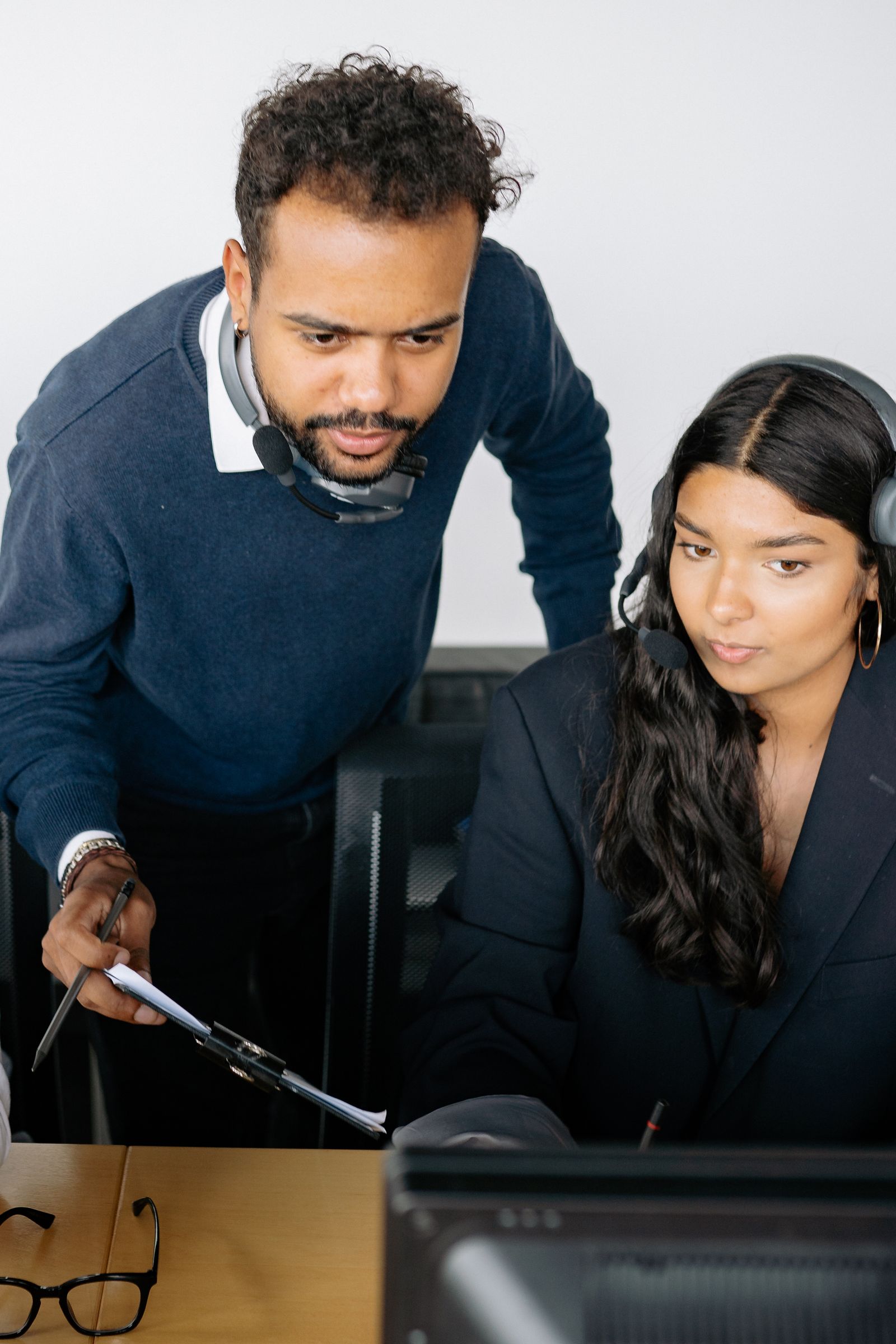 Professionals collaborating with AI technology in a modern digital workplace