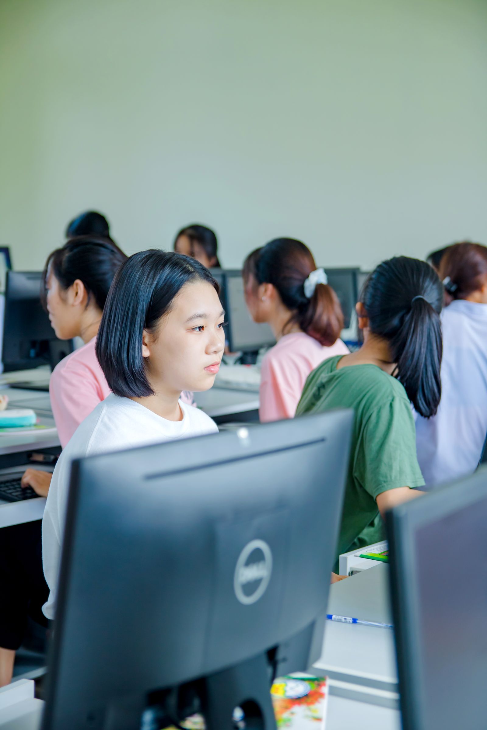 Students learning with an AI assistant on tablets in a bright classroom