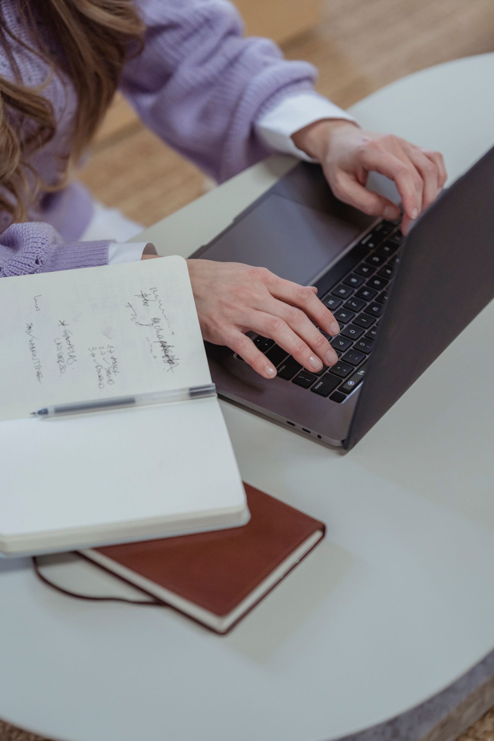 Writer using an AI writing assistant on a laptop with glowing text suggestions