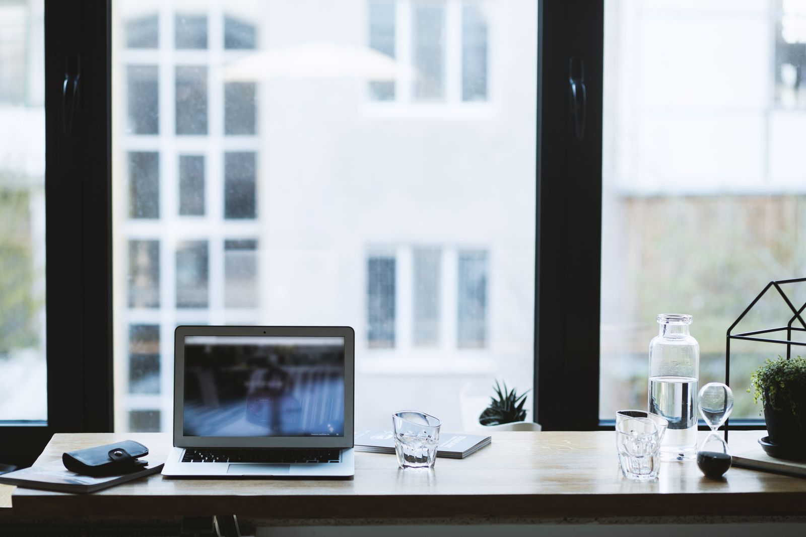 Five free AI productivity tools arranged on a desk with a laptop and calendar
